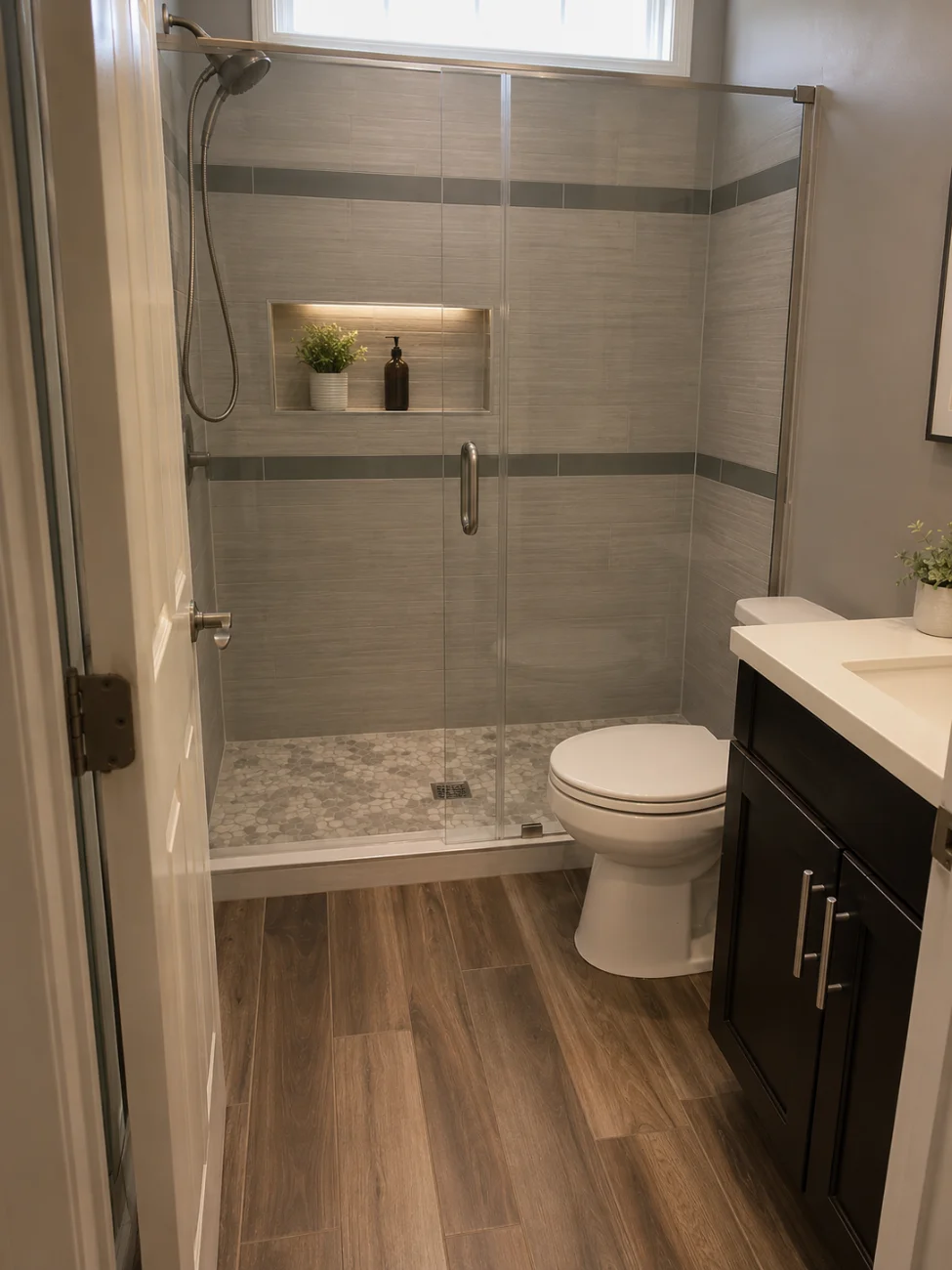 Remodeled bathroom with tiled shower and glass door